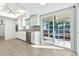 Bright eat-in kitchen with white cabinetry and stainless steel appliances, leading to patio at 1684 Leisure World --, Mesa, AZ 85206