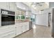 Bright eat-in kitchen with a ceiling fan, white cabinetry, and stainless steel dishwasher at 1684 Leisure World --, Mesa, AZ 85206