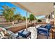Inviting covered patio with comfortable seating and a serene view of the landscaped backyard at 1684 Leisure World --, Mesa, AZ 85206