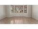 Spacious bedroom featuring a bay window with views of mature landscaping, and easy-to-clean tile flooring at 16902 W Marcos De Niza Dr, Surprise, AZ 85387