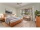 Inviting bedroom with a large bay window, natural light, and a comfortable king bed at 16902 W Marcos De Niza Dr, Surprise, AZ 85387