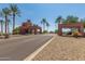 Entrance to a private community shows a well-maintained gate with lush landscaping at 16902 W Marcos De Niza Dr, Surprise, AZ 85387
