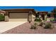 Single-story home featuring desert landscaping, a two-car garage, and a welcoming entrance at 16902 W Marcos De Niza Dr, Surprise, AZ 85387