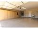 Spacious garage with epoxy flooring, a utility sink and built-in cabinets offers ample storage space at 16902 W Marcos De Niza Dr, Surprise, AZ 85387