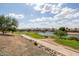Picturesque golf course with a scenic pond and surrounding residential homes adds beauty to the landscape at 16902 W Marcos De Niza Dr, Surprise, AZ 85387