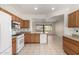 Kitchen showcasing oak cabinetry, modern appliances, and an open layout with views to living area at 16902 W Marcos De Niza Dr, Surprise, AZ 85387