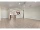 Inviting living room seamlessly connects to the kitchen area with open layout and neutral color palette at 16902 W Marcos De Niza Dr, Surprise, AZ 85387