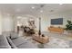 Cozy living room open to the kitchen, featuring neutral tones and modern furniture at 16902 W Marcos De Niza Dr, Surprise, AZ 85387