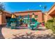 Charming outdoor patio with colorful furniture, string lights, and landscaping, perfect for relaxing and entertaining at 16902 W Marcos De Niza Dr, Surprise, AZ 85387