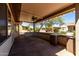 Covered patio with ceiling fan offers a great space to enjoy the outdoors and desert landscaping at 16902 W Marcos De Niza Dr, Surprise, AZ 85387