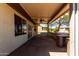 Covered patio with ceiling fan offers a great space to enjoy the outdoors and desert landscaping at 16902 W Marcos De Niza Dr, Surprise, AZ 85387