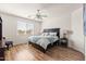 Primary bedroom featuring a ceiling fan, natural light, and wood-look floors at 1705 W Stephanie Ln, San Tan Valley, AZ 85144