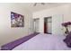 Bedroom featuring a painting, sliding door closet, and ensuite bathroom at 1705 W Stephanie Ln, San Tan Valley, AZ 85144