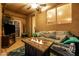 Enjoy the covered patio with a fireplace, comfortable seating, and ceiling fan for outdoor entertaining at 1705 W Stephanie Ln, San Tan Valley, AZ 85144