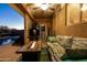Comfortable covered patio featuring a fireplace and fan, providing a cozy outdoor space at 1705 W Stephanie Ln, San Tan Valley, AZ 85144