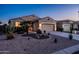 Charming home with xeriscaped front yard featuring desert plants and a spacious driveway at 1705 W Stephanie Ln, San Tan Valley, AZ 85144
