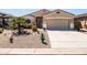 Well-maintained home featuring xeriscaping, desert landscaping, and a two-car garage at 1705 W Stephanie Ln, San Tan Valley, AZ 85144