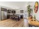 Well-equipped kitchen with stainless steel appliances, dark cabinets, island with barstools and bright natural light at 1705 W Stephanie Ln, San Tan Valley, AZ 85144