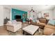 Cozy living room featuring a large sectional sofa, armchair, and a pop of color from the accent wall at 1705 W Stephanie Ln, San Tan Valley, AZ 85144