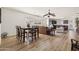 Open-concept living space with hardwood floors, a dining area, and seamless flow to the kitchen at 1705 W Stephanie Ln, San Tan Valley, AZ 85144