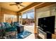 Inviting outdoor patio area with comfortable seating, ceiling fan, and access to the backyard at 1705 W Stephanie Ln, San Tan Valley, AZ 85144