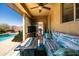Covered patio with outdoor furnishings, fire pit, and a view of the sparkling swimming pool at 1705 W Stephanie Ln, San Tan Valley, AZ 85144