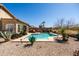 A private pool with desert landscaping and a lounge chair invites relaxation under a clear blue sky at 1705 W Stephanie Ln, San Tan Valley, AZ 85144