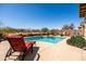 Inviting pool with a poolside chaise lounge and desert landscaping at 1705 W Stephanie Ln, San Tan Valley, AZ 85144