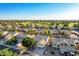 Expansive aerial view of a residential neighborhood, golf course, and mountain backdrop on a bright sunny day at 1750 N Abner --, Mesa, AZ 85205