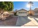 Charming single-story home with a well-manicured lawn, desert landscaping and a private two-car garage at 1750 N Abner --, Mesa, AZ 85205
