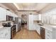 Well-lit kitchen with stainless steel appliances, white cabinets, and quartz countertops at 1750 N Abner --, Mesa, AZ 85205