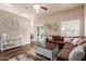 Spacious living room with a sectional sofa, stylish coffee table, and sliding glass doors to the patio at 1750 N Abner --, Mesa, AZ 85205