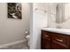 Small, well-lit bathroom featuring stylish mirror, a decorative waterfall print, toilet, and dark wood vanity at 21647 S 223Rd Pl, Queen Creek, AZ 85142