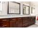 Bathroom featuring dual sinks, dark wood cabinets, and a granite countertop at 21647 S 223Rd Pl, Queen Creek, AZ 85142