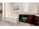 Bathroom with a soaking tub, vanity with granite countertop, and natural light at 21647 S 223Rd Pl, Queen Creek, AZ 85142