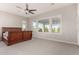 Spacious bedroom with neutral carpet, ceiling fan, and natural light from a window at 21647 S 223Rd Pl, Queen Creek, AZ 85142