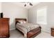 Bedroom with a full bed, dresser, and a window bringing in natural light at 21647 S 223Rd Pl, Queen Creek, AZ 85142