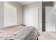 Bedroom with a full bed, slider closet door, and a view to a connecting room at 21647 S 223Rd Pl, Queen Creek, AZ 85142
