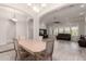 Open-concept dining area with tile flooring, view to the living area and abundant natural light at 21647 S 223Rd Pl, Queen Creek, AZ 85142