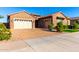 Charming single-story home featuring a brick exterior, three-car garage, and a beautifully paved driveway at 21647 S 223Rd Pl, Queen Creek, AZ 85142