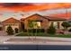 Charming single-story brick home featuring a well-manicured lawn and beautiful desert landscaping at 21647 S 223Rd Pl, Queen Creek, AZ 85142