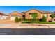 Charming single-story brick home featuring a well-manicured lawn and beautiful desert landscaping at 21647 S 223Rd Pl, Queen Creek, AZ 85142