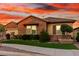 Charming single-story brick home featuring a well-manicured lawn and beautiful desert landscaping at 21647 S 223Rd Pl, Queen Creek, AZ 85142