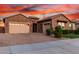 Beautiful home boasts a brick driveway and two-car garage with ample space for parking at 21647 S 223Rd Pl, Queen Creek, AZ 85142