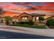 Charming single-story brick home featuring a well-manicured lawn and beautiful desert landscaping at 21647 S 223Rd Pl, Queen Creek, AZ 85142