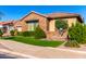 This well-maintained home is surrounded by lush greenery and a colorful, low-maintenance landscape at 21647 S 223Rd Pl, Queen Creek, AZ 85142