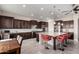 Gourmet kitchen featuring dark wood cabinetry, granite countertops, and stainless steel appliances at 21647 S 223Rd Pl, Queen Creek, AZ 85142
