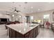 Spacious kitchen island with granite countertops, bar seating, and stainless steel sink at 21647 S 223Rd Pl, Queen Creek, AZ 85142