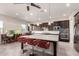 Modern kitchen with granite countertops, stainless steel appliances, and a large center island with seating at 21647 S 223Rd Pl, Queen Creek, AZ 85142