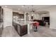 Open kitchen with a large center island, dark wood cabinets, and views of the living area at 21647 S 223Rd Pl, Queen Creek, AZ 85142
